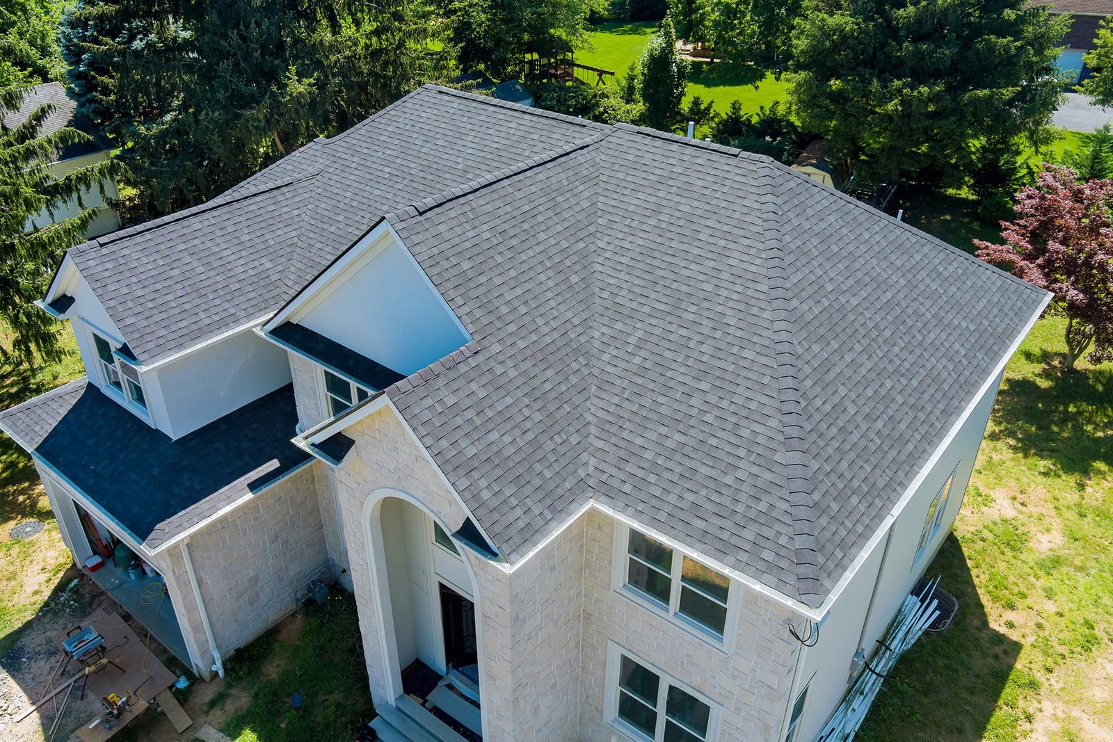 Aerial view of a two-story home with a gray shingle roof